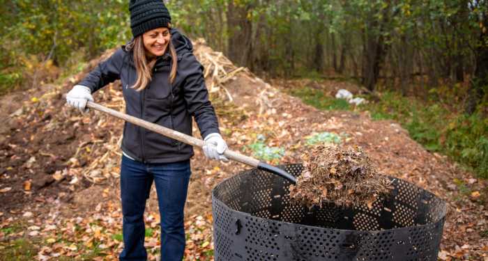woman shoveling compost