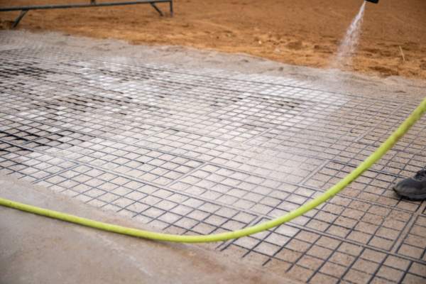 hosing down the infill material in horse stall flooring units