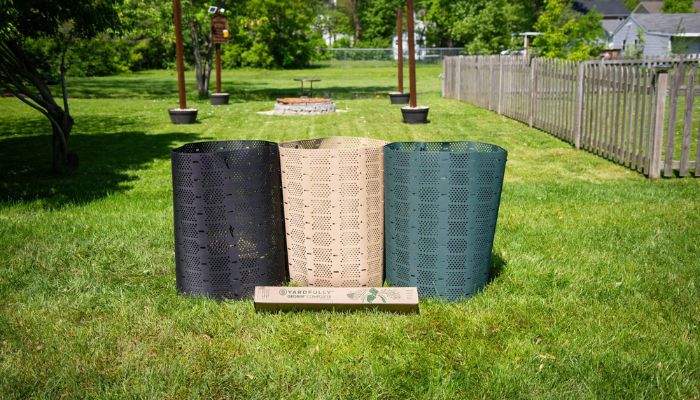 black, tan, and black geobin composters in backyard